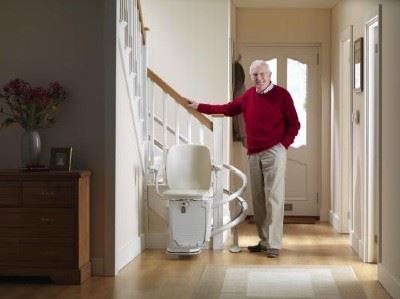 man stands near stairlift